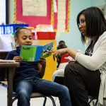 Martinez Fellow Treneicia Gardner offers reading support to a student.
