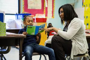 Martinez Fellow Treneicia Gardner offers reading support to a student.